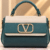 Teal_and_ivory_crystal-emblem_handbag_cleaned